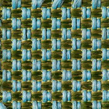 Close up of blue and green woven fabric texture with a geometric basket weave pattern