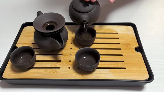 Experience the serene elegance of a traditional tea ceremony. Witness the careful preparation and pouring of tea into delicate cups, showcasing the beauty of this timeless ritual.