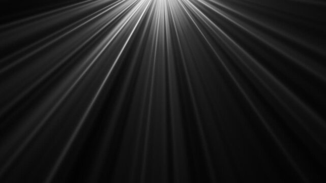 Dynamic light rays emanating from the top left corner against a dark background, creating a dramatic spotlight effect