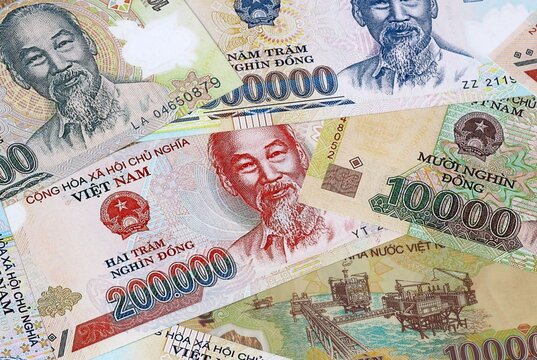 Big amount of Vietnamese dong money banknotes. Vietnam cash bills of VND currency close up