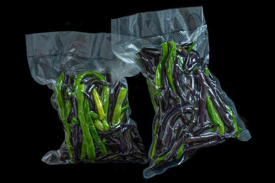 Two Bags Contain Green and Purple Peppers