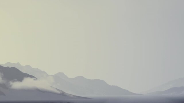 Cold winter landscape showing tall snowy mountain ranges with white clouds resting on rocky peaks under a bright overcast sky during daylight hours