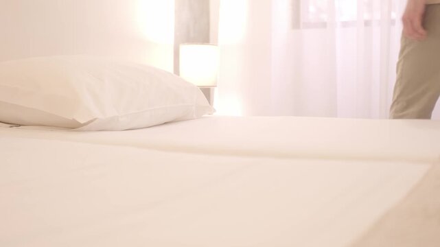Young guy lying in bed, getting ready to sleep, falling asleep, bedtime habits, tired body, bedtime ritual, home comfort, early morning