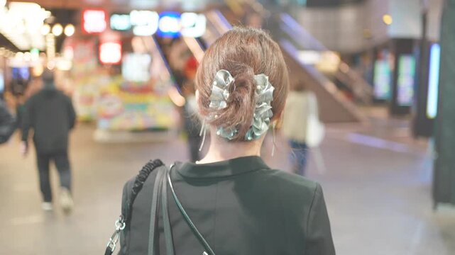 Urban Lifestyle Scene With Woman Walking Through Indoor Shopping Street, Slow Motion