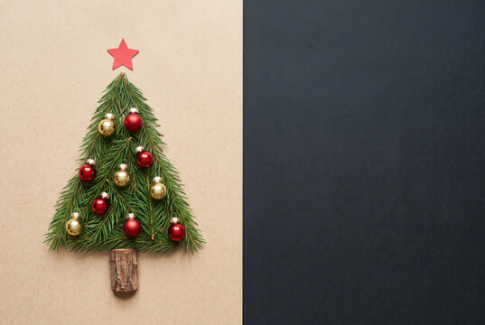 Merry Christmas and happy new year greetings in vertical top view dark blackboard with natural eco decorated christmas tree pine in cardboard.Xmas winter holiday season social media card background