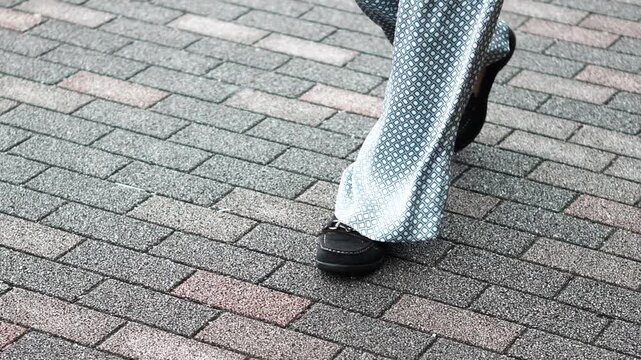Close-Up of Walking on Stone Pavement, Slow Motion