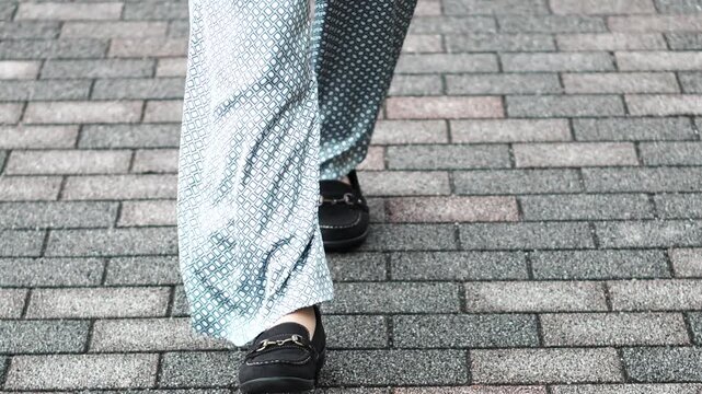 Close-Up of Walking on Stone Pavement, Slow Motion