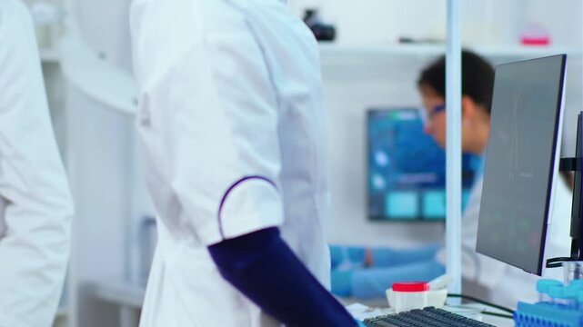 Computer, scientist and research data entry as Black woman researcher types with gloves while studying a monitor, for biotechnology, digital analysis, scientific workflow and medical research.