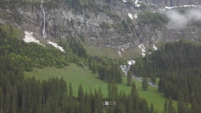 Snow patches and waterfalls, Bi de Sibe Br&uuml;nne, sources of the Simme, drone shot, Lenk, Bern, Switzerland