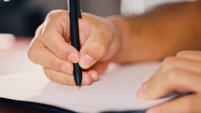 Hand Signing Paper With Black Pen Close Up