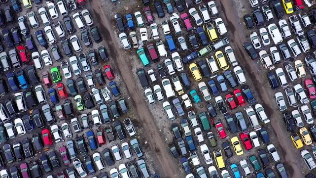 Aerial view of car scrap yard showing rows of abandoned vehicles for disassembly in Burgas, Bulgaria