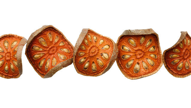Isolated dried bael fruit slices in a horizontal row, showcasing unique pattern and seeds.
