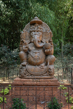 Indian god in the shape of an elephant (Ganesha) outdoors in a park.