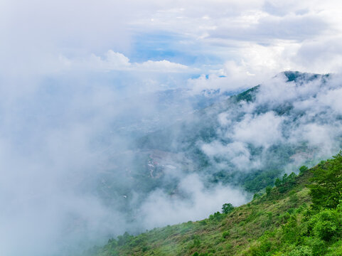 Misty Mountain Landscape with Clouds and Green Hills