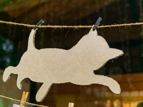 Cardboard cat silhouette hanging on a rope