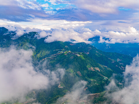 Aerial view of misty green mountains and terraced fields in Nantou