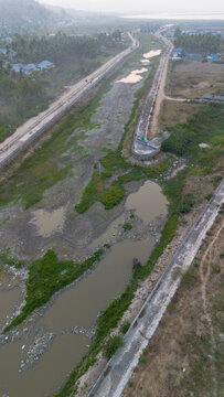 Aerial View of Bridge Over River in Residential Area