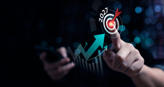 Business growth target concept with professional touching virtual 2027 goal and rising chart showing performance increase, strategic planning, revenue growth and future success