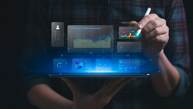Business data analytics concept with professional using stylus on virtual dashboard showing KPI metrics, performance charts, statistics, reports and digital decision making