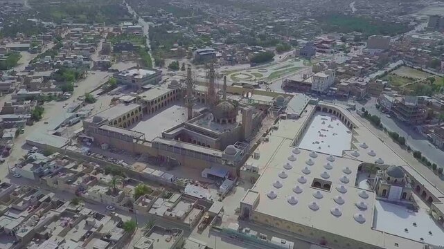 Wide aerial view of the Al-Sahla Mosque complex and minarets over Kufa, Najaf, Iraq