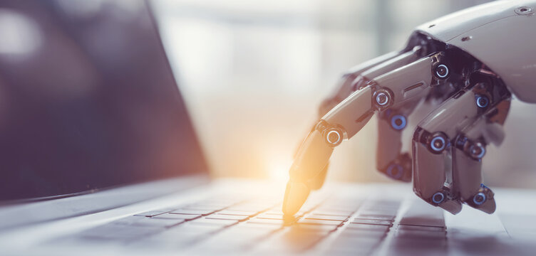 Robotic fingers typing on a laptop keyboard, representing artificial intelligence, automation, and the future of digital work