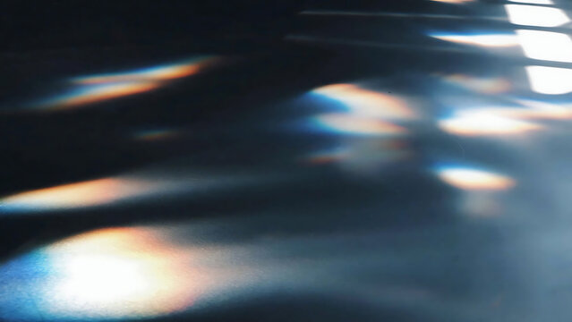 Close-up of abstract light rays and reflections on a dark water surface illustration