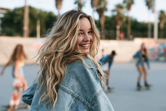 western girl wearing washed denim jacket, smiling with 90s grunge style fashion