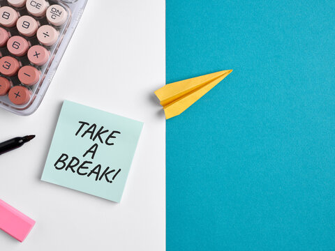 Take a break sticky note and paper airplane flying symbolizing freedom and vacation