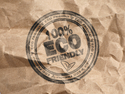 100 percent eco friendly stamp on crumpled brown paper