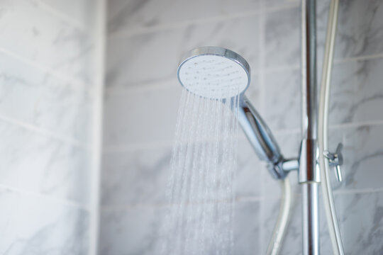 The shower is activated to clean. water flowing out of the shower