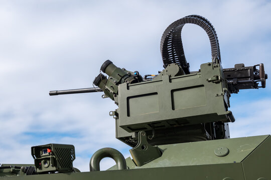 Armored vehicle turret with machine gun against blue sky