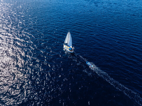 Aerial view of sailboat in the deep blue sea in Sardinia, Italy