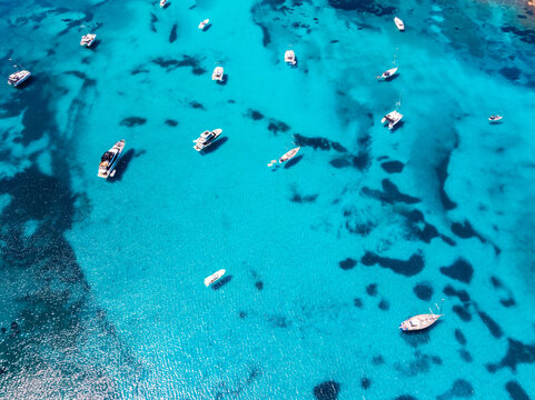 Aerial view of yachts anchored in turquoise water at Brandinchi beach, Sardinia