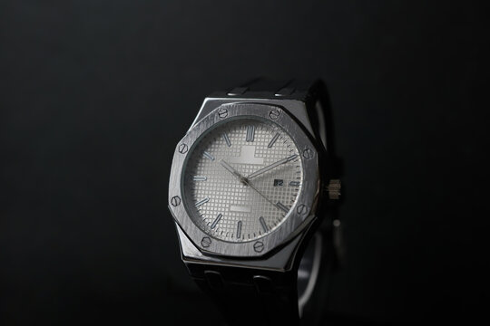 Silver Analog Wristwatch with White Dial on Dark Background