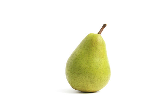 Side view of whole fresh organic green pear with stem casting shadow isolated white background