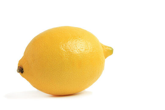 Front view of whole fresh organic yellow lemon casting soft shadow isolated white background