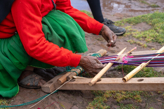 Andean woman weaving traditional textile on Taquile Island, Lake Titicaca, Peru