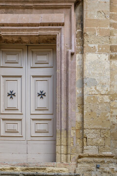 Light Grey Painted Wooden Double Door Featuring Rectangular Molded Panels and Carved Black Maltese Cross Symbols