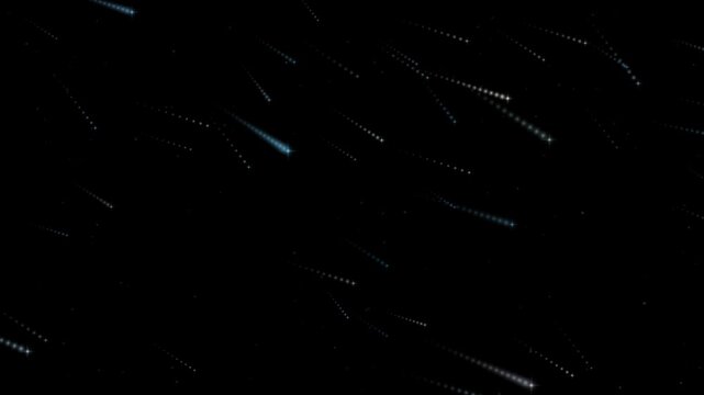 Icy blue comet trails streaking diagonally across a black background as bright heads pull fine fading sparkle tails behind them through three layers of depth