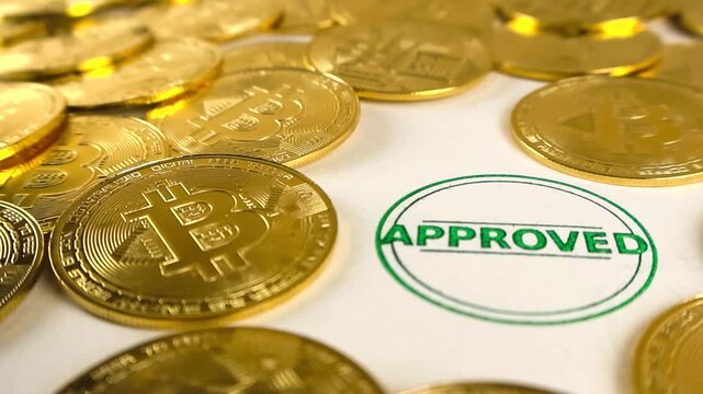 Shiny gold Bitcoin tokens surrounding a green circular approved rubber stamp imprint on document paper, representing official cryptocurrency legalization and finance acceptance