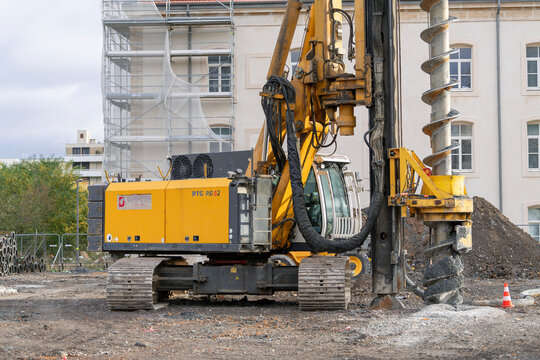 Nancy, France - October 24th 2026 : View on a yellow drilling rig Bauer RTG RG 22 S for special foundations on a construction site before the construction of a residential building.