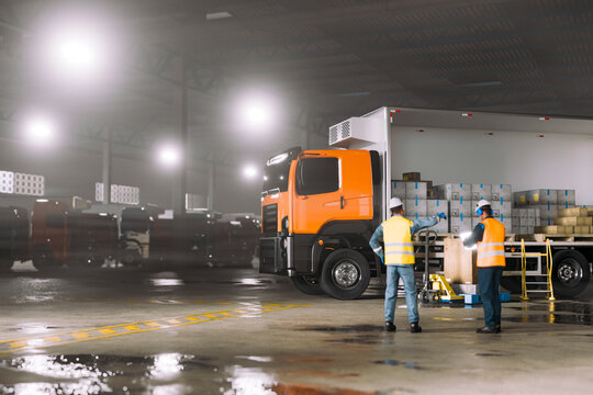 3D Orange freight truck and warehouse workers coordinating nighttime cargo distribution