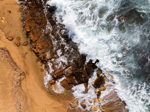 Aerial view of a storm wave on a rocky coast