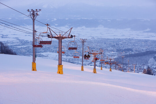 Ski lift carrying skiers up snowy slope hokkaido japan