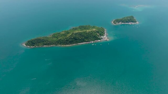 Aerial view of lush green islands surrounded by calm sea and coastline. Darahuway Guti, Darahuway Dako. Samar, Philippines