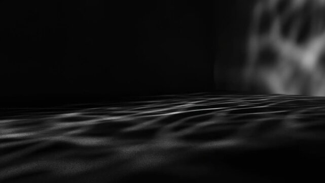 Abstract light ripples across a dark textured surface beneath shifting shadows. Title sequence, music event, and website header.