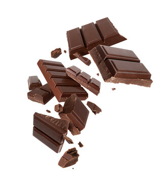 Flying chocolate bar pieces with crumbs and chunks falling in motion, levitation food photography isolated on white background
