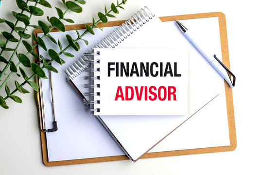 Financial advisor concept with notebook, clipboard, pen and green leaves, representing personal finance planning