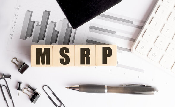 Msrp concept with financial charts, calculator and office supplies illustrating retail pricing and business analysis