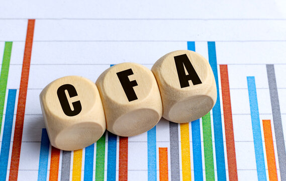 Cfa certification concept with wooden blocks on a colorful financial chart, representing investment analysis and accounting